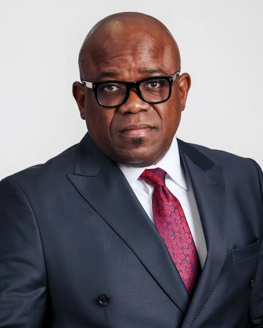 Portrait of Baron Mbala in a navy suit.